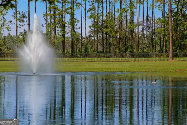 a view of a golf club with a backyard of the house