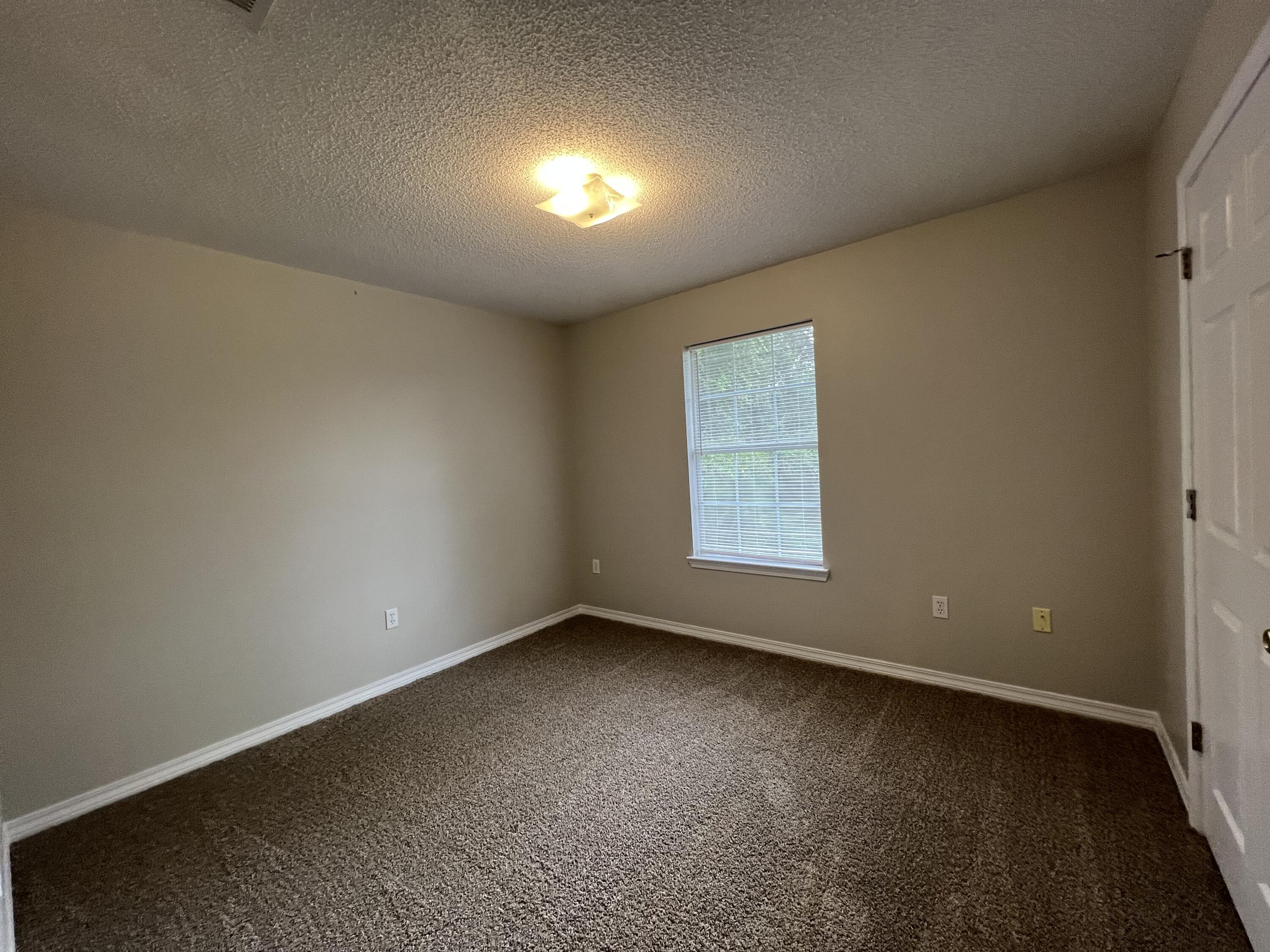 224 Runnymeade Drive Crestview, FL 32539 - Photo 10 of 11 an empty room with a empty space and window