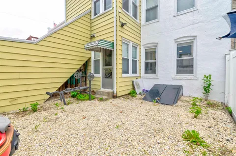 a view of a backyard with chair and table