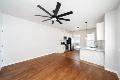 a view of kitchen with sink and wooden floor