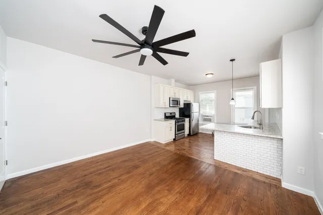 a view of kitchen with sink and wooden floor