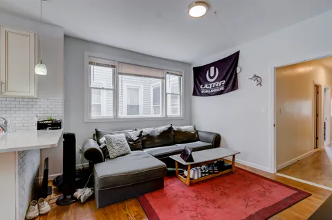 a living room with furniture and a rug