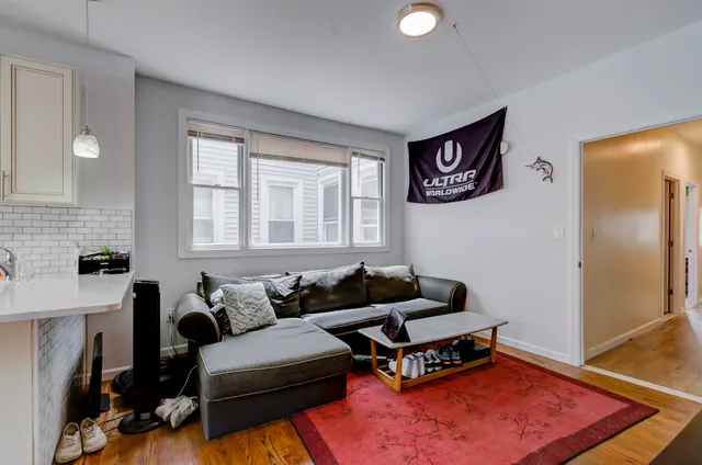 a living room with furniture and a rug