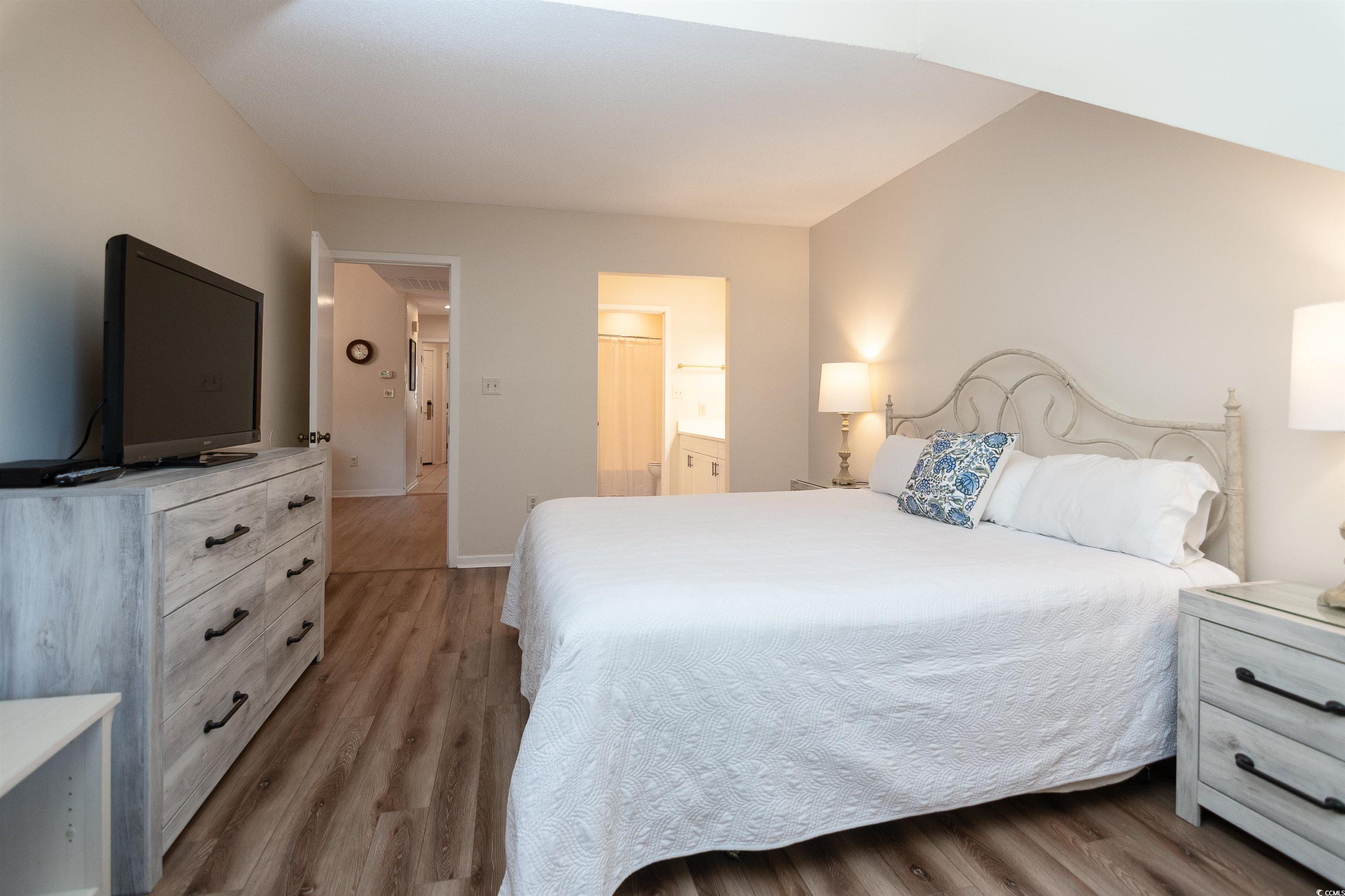 175 St Clears Way, Unit 23I Myrtle Beach, SC 29572 - Photo 15 of 39 Bedroom featuring light wood-style flooring and ensuite bath
