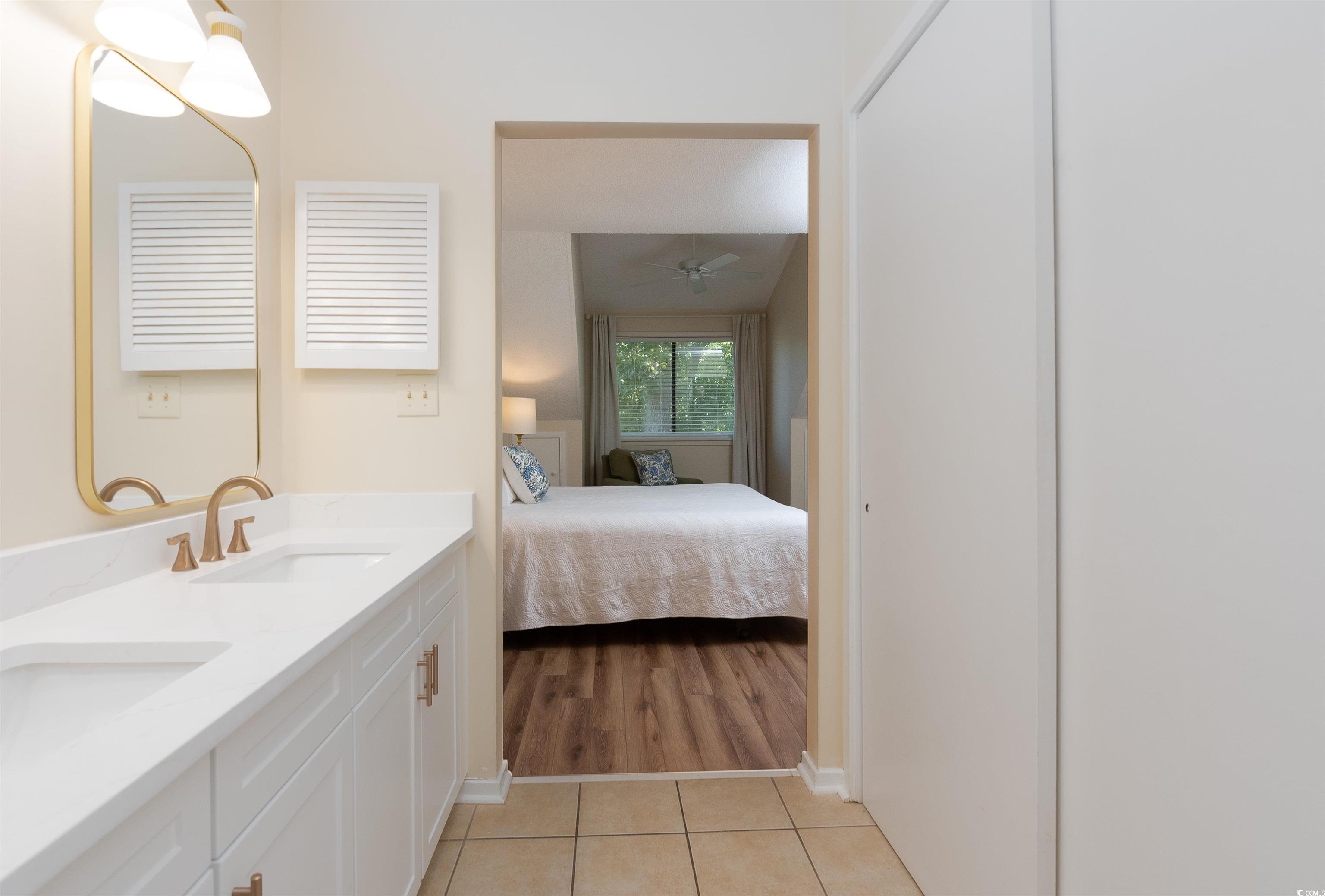 175 St Clears Way, Unit 23I Myrtle Beach, SC 29572 - Photo 20 of 39 Bathroom with double vanity, connected bathroom, light tile patterned floors, and ceiling fan