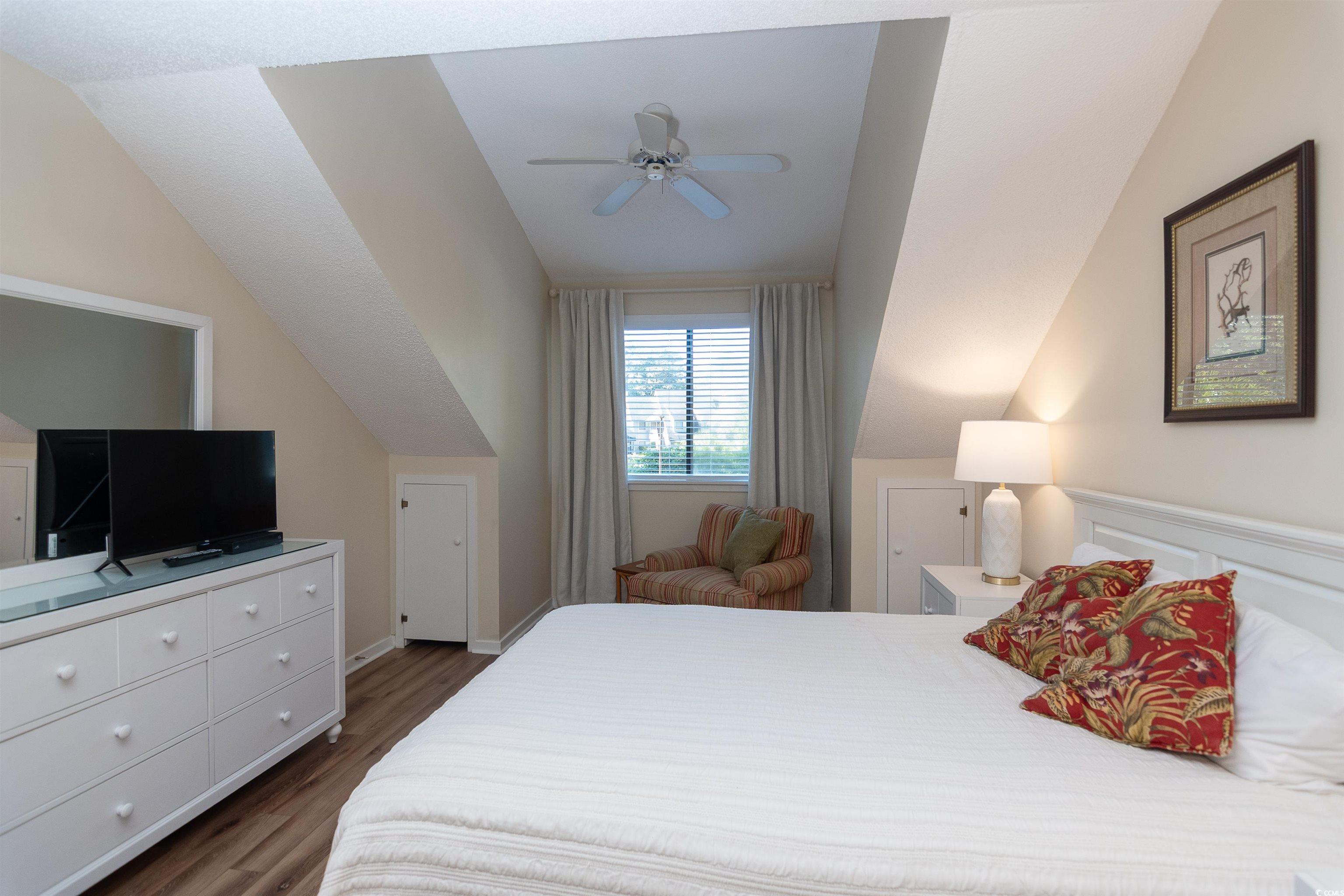 175 St Clears Way, Unit 23I Myrtle Beach, SC 29572 - Photo 23 of 39 Bedroom featuring dark wood-style flooring, ceiling fan, and vaulted ceiling