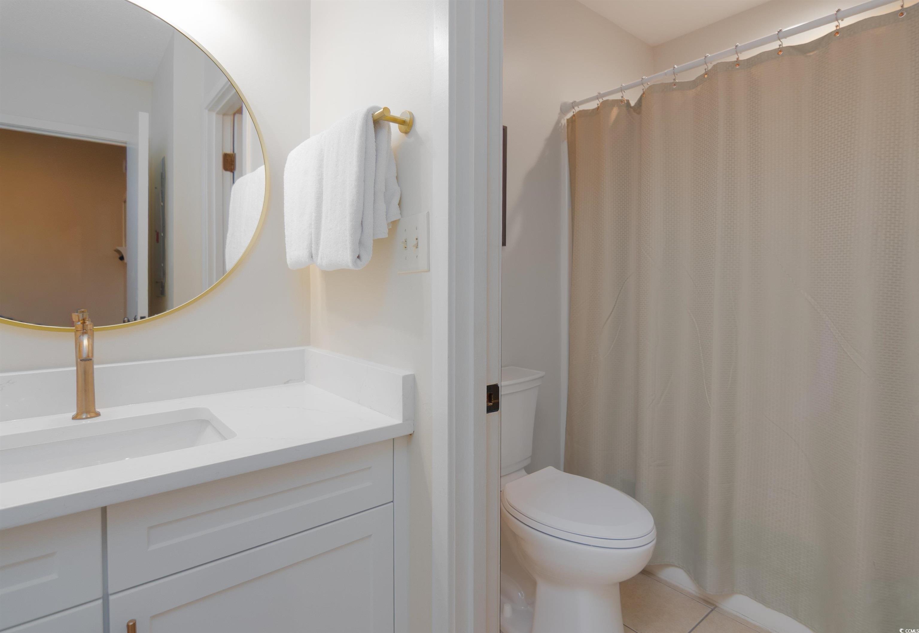 175 St Clears Way, Unit 23I Myrtle Beach, SC 29572 - Photo 25 of 39 Bathroom featuring vanity, curtained shower, and light tile patterned floors
