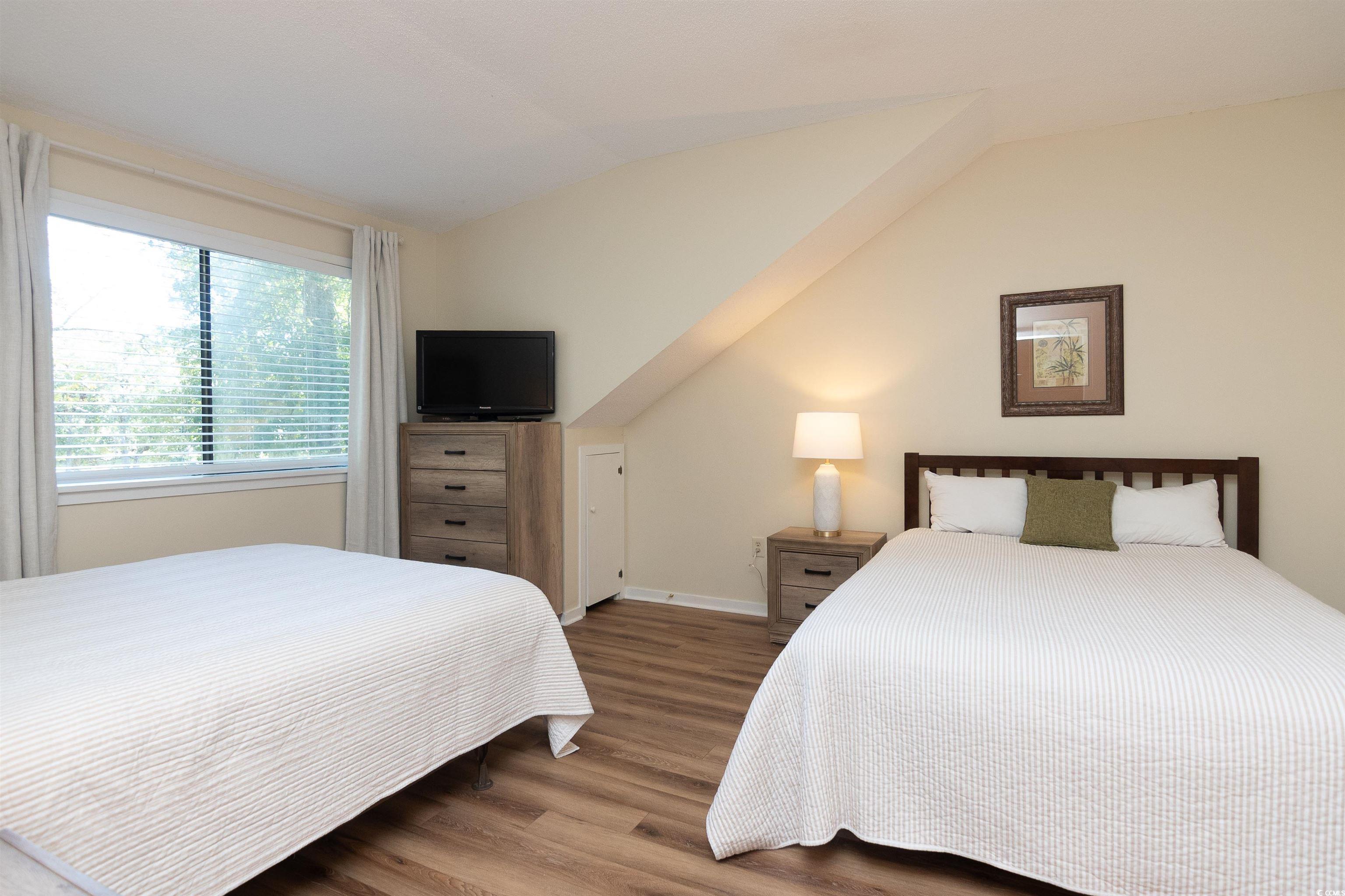 175 St Clears Way, Unit 23I Myrtle Beach, SC 29572 - Photo 27 of 39 Bedroom featuring wood finished floors and vaulted ceiling