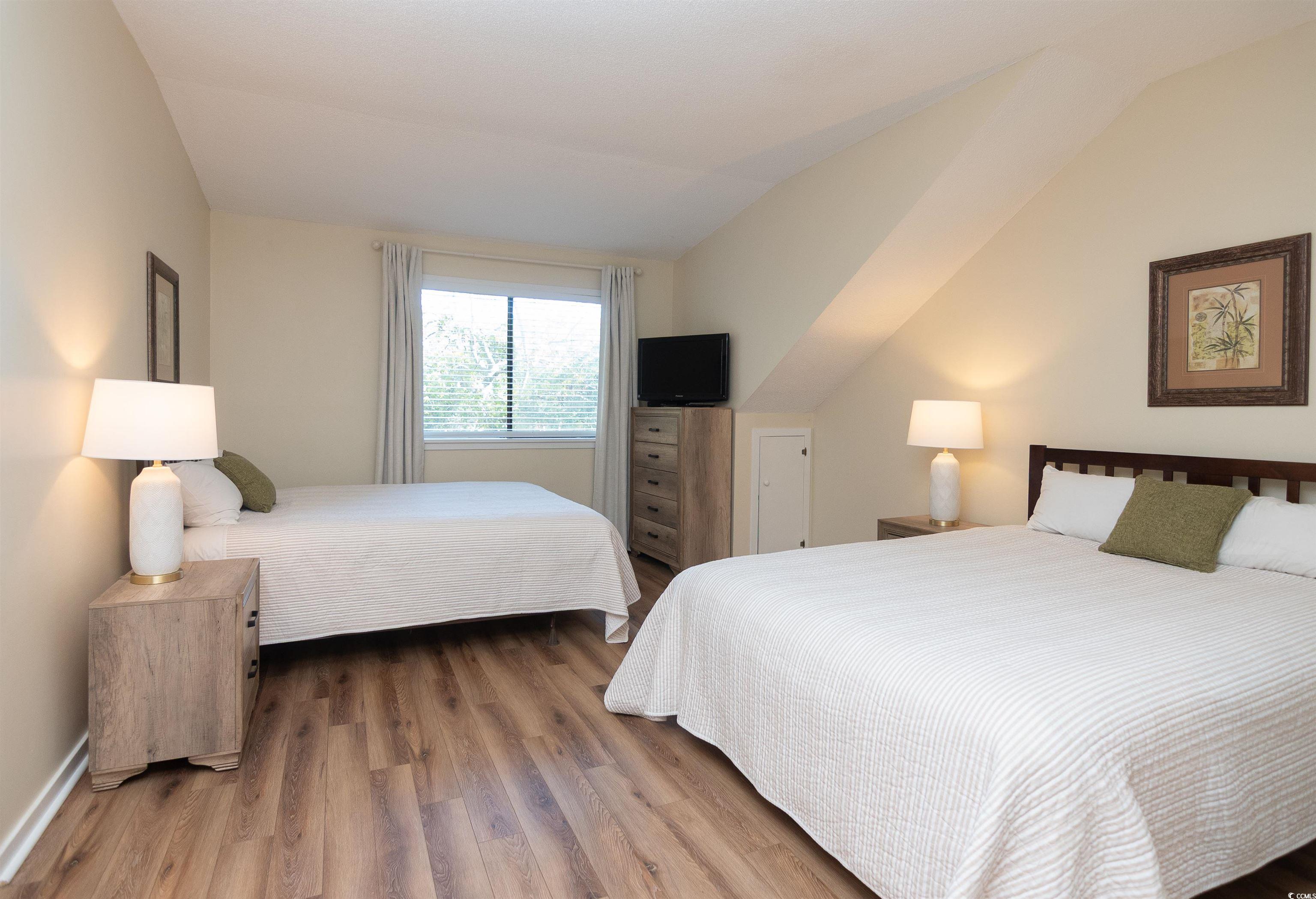 175 St Clears Way, Unit 23I Myrtle Beach, SC 29572 - Photo 28 of 39 Bedroom with wood finished floors and lofted ceiling