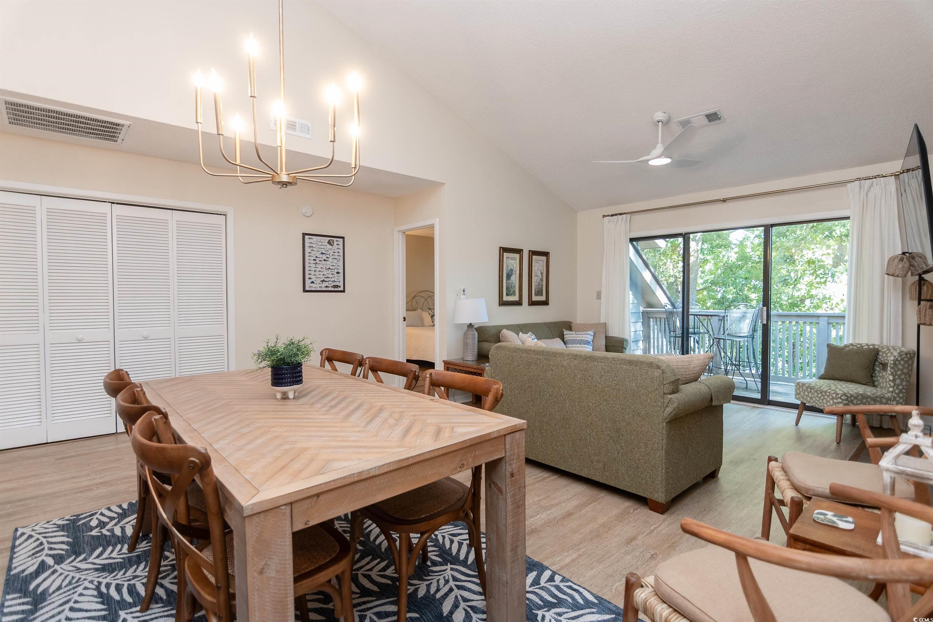 175 St Clears Way, Unit 23I Myrtle Beach, SC 29572 - Photo 9 of 39 Dining space with lofted ceiling, wood finished floors, a chandelier, and ceiling fan