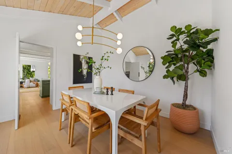 a dining room with furniture and a mirror
