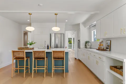 a large kitchen with a table and chairs