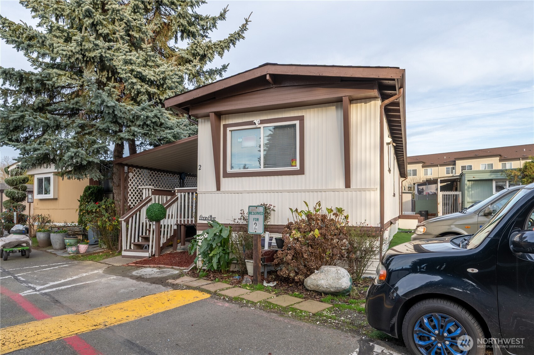 24415 64th Avenue South, Unit 2 Kent, WA 98032 - Photo 2 of 23 a front view of a house with garden