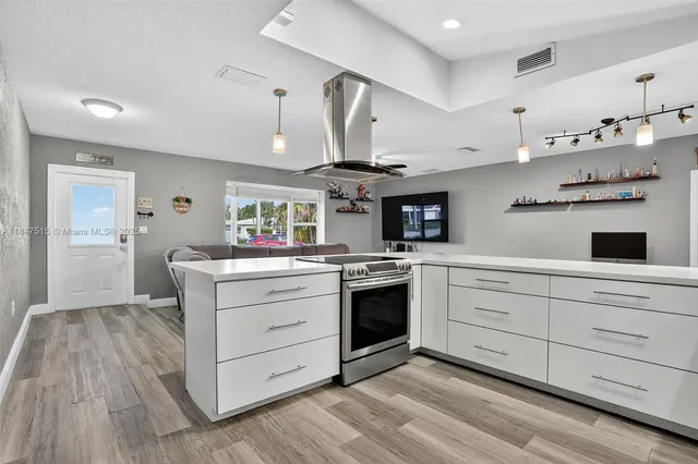 a kitchen with a refrigerator stove and wooden cabinets