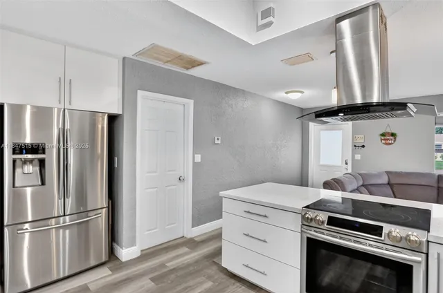 a kitchen with a sink and refrigerator