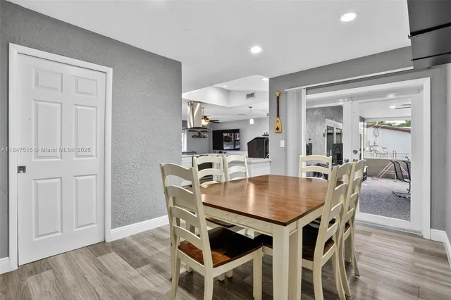 a bedroom with a bed and dresser with mirror