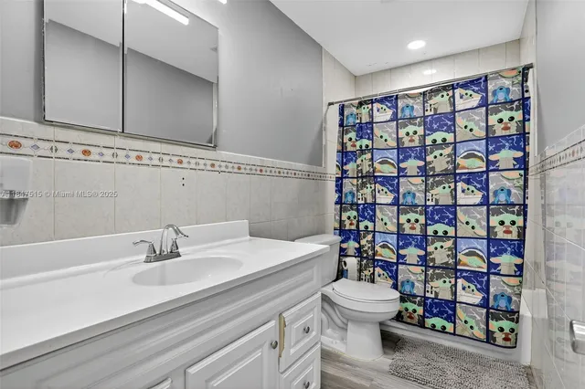 a bathroom with a sink vanity and mirror