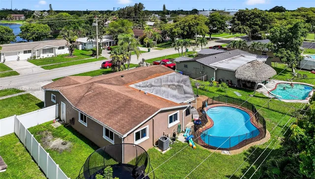 an aerial view of a house with outdoor space patio and trees