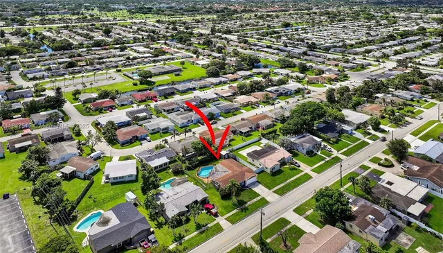 an aerial view of residential houses with outdoor space