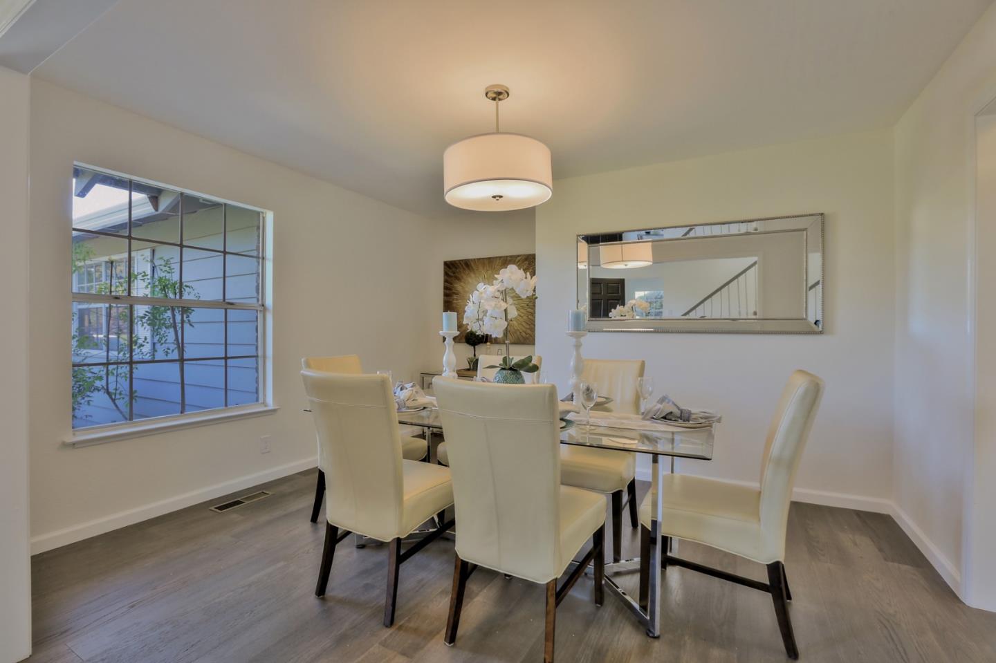 970 Covington Road Los Altos, CA 94024 - Photo 12 of 47 a dining room with wooden floor and a chandelier