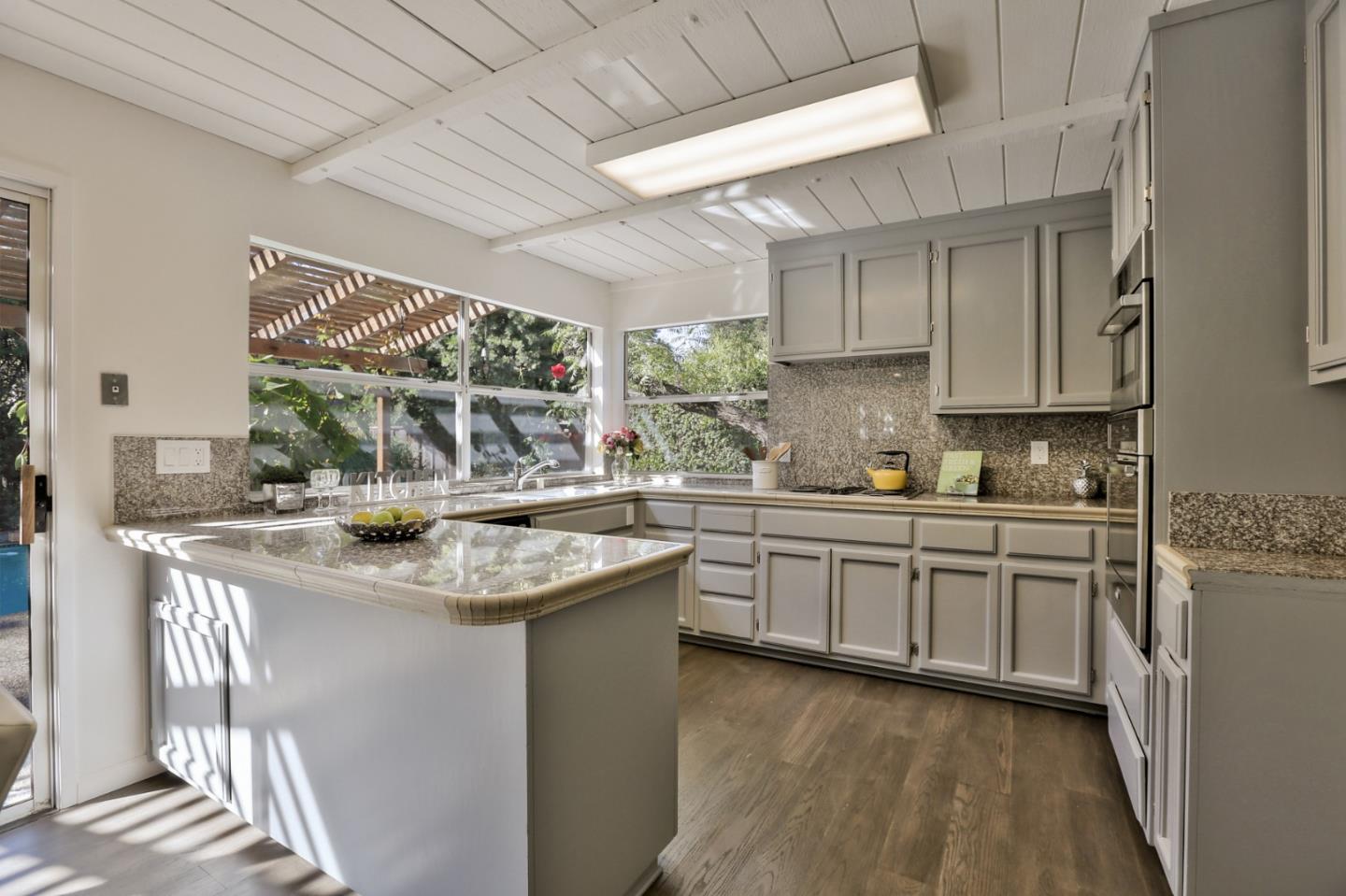 970 Covington Road Los Altos, CA 94024 - Photo 15 of 47 a kitchen with stainless steel appliances granite countertop a sink stove and cabinets