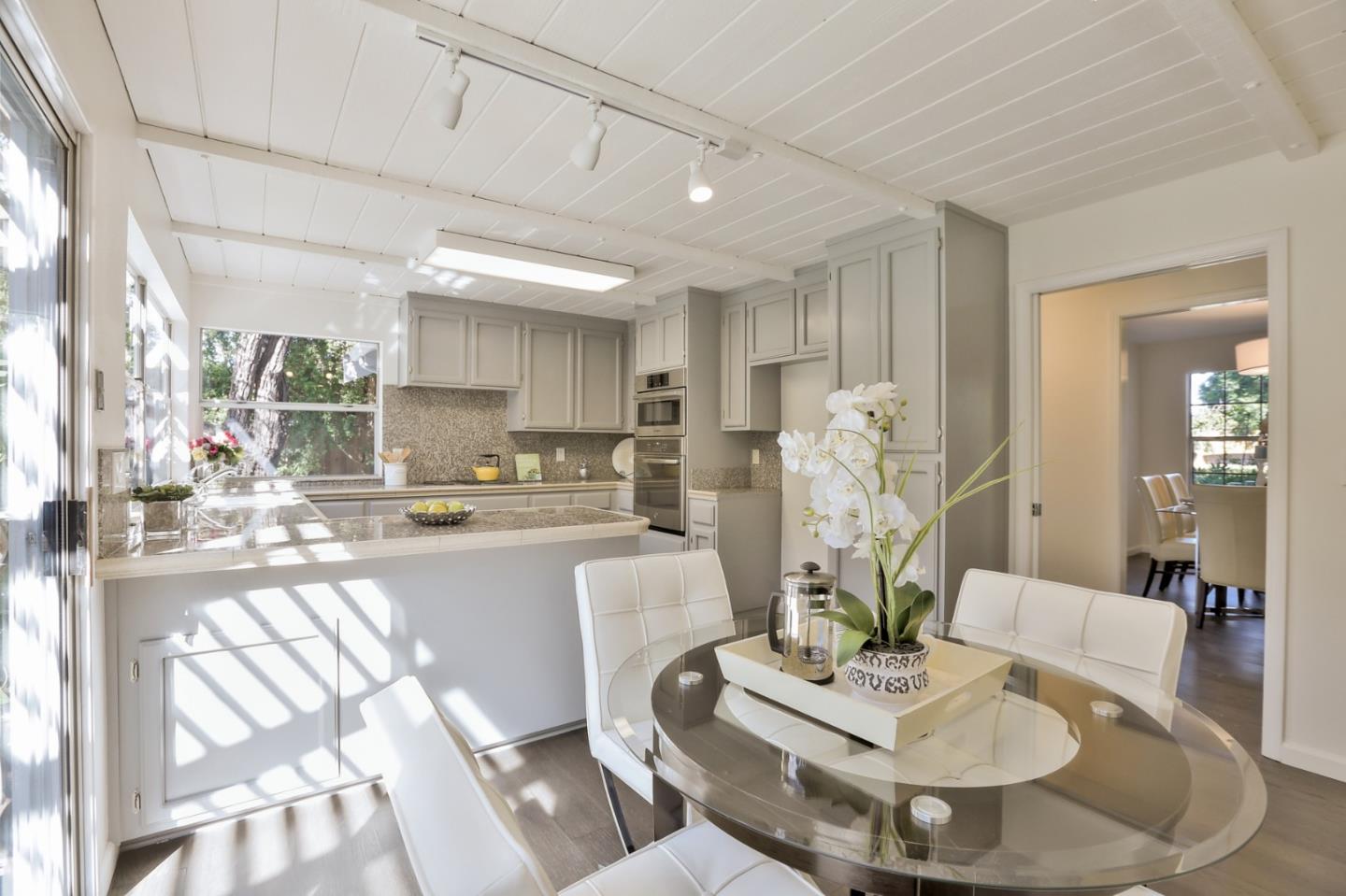970 Covington Road Los Altos, CA 94024 - Photo 21 of 47 a living room with furniture and a dining table with kitchen view