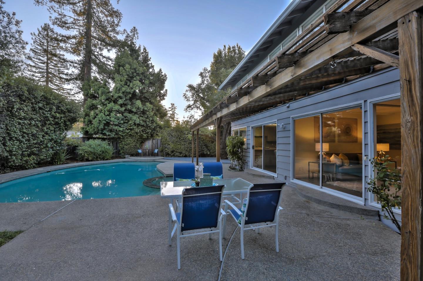 970 Covington Road Los Altos, CA 94024 - Photo 43 of 47 a view of a patio with table and chairs and potted plants