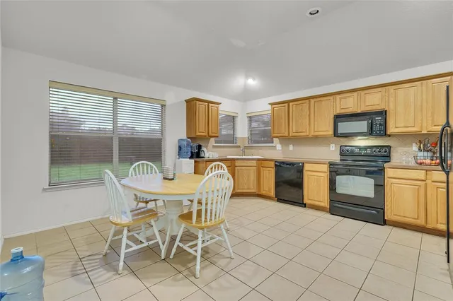 a kitchen with a sink cabinets and window