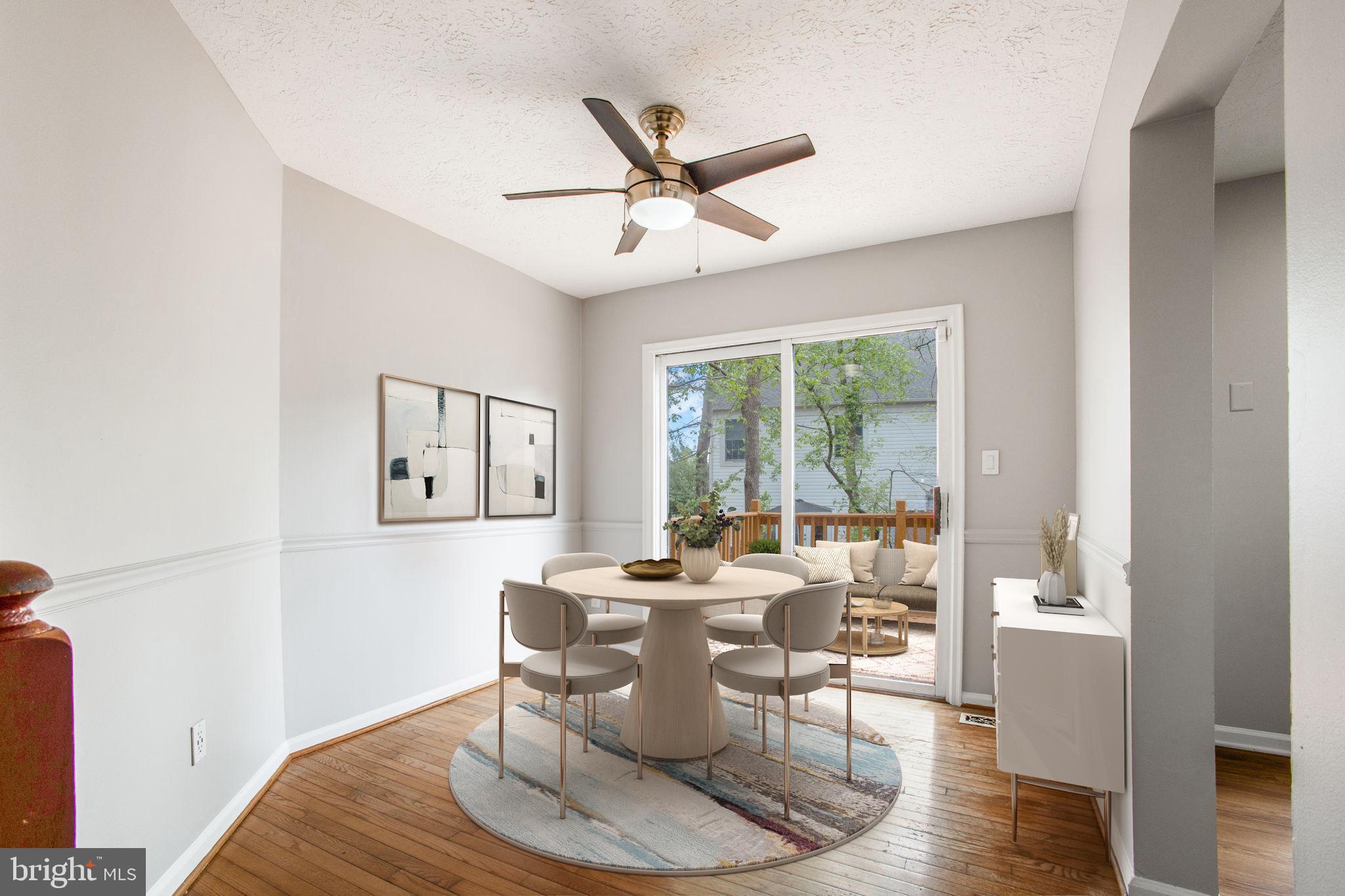 2102 Commissary Circle Odenton, MD 21113 - Photo 12 of 54 a dining room with wooden floor and a ceiling fan