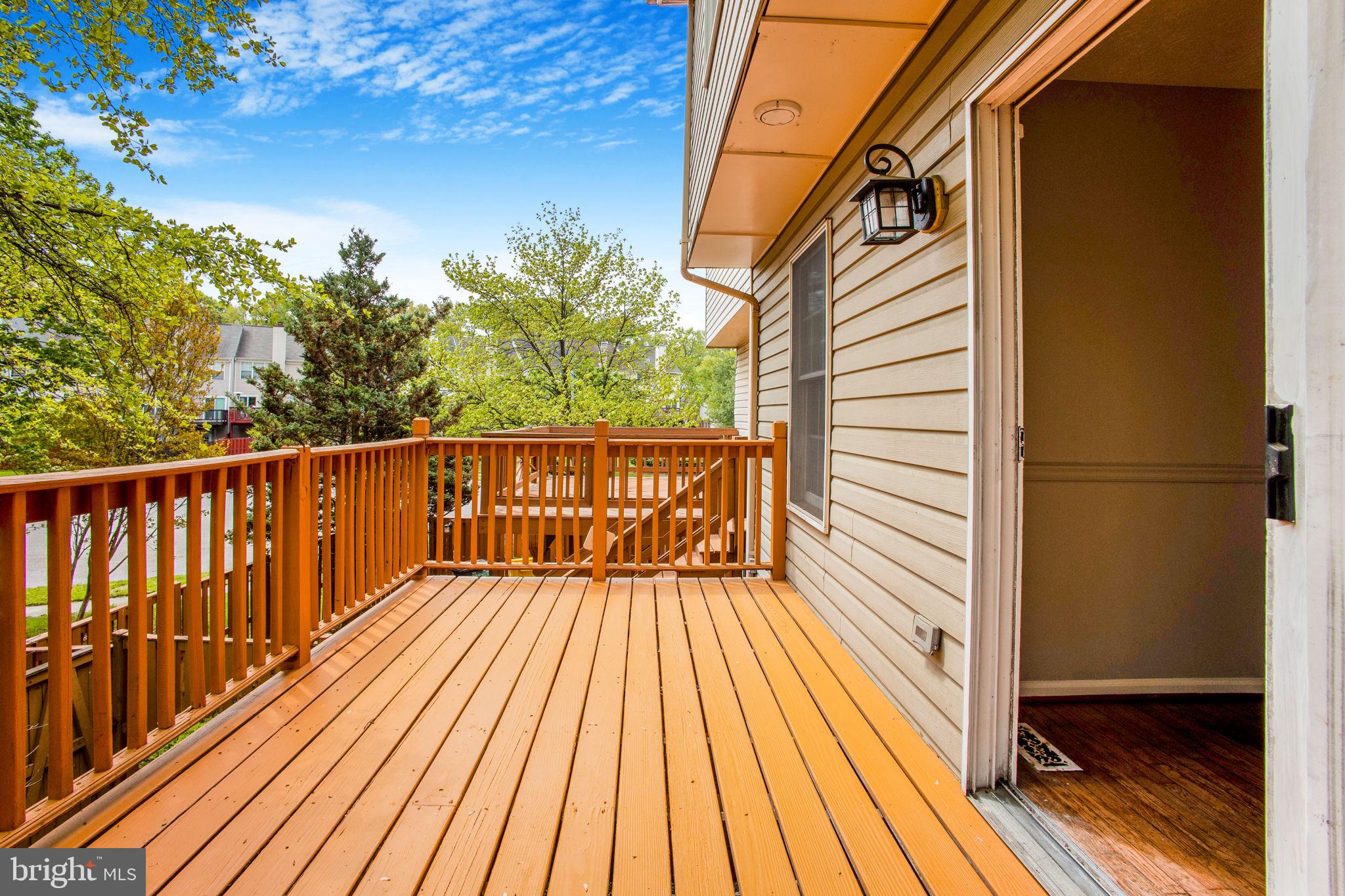 2102 Commissary Circle Odenton, MD 21113 - Photo 20 of 54 a view of a balcony with wooden floor and fence