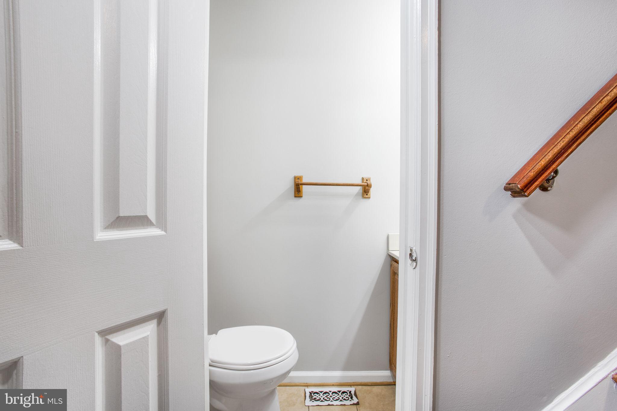 2102 Commissary Circle Odenton, MD 21113 - Photo 21 of 54 a white toilet sitting next to a shower curtain
