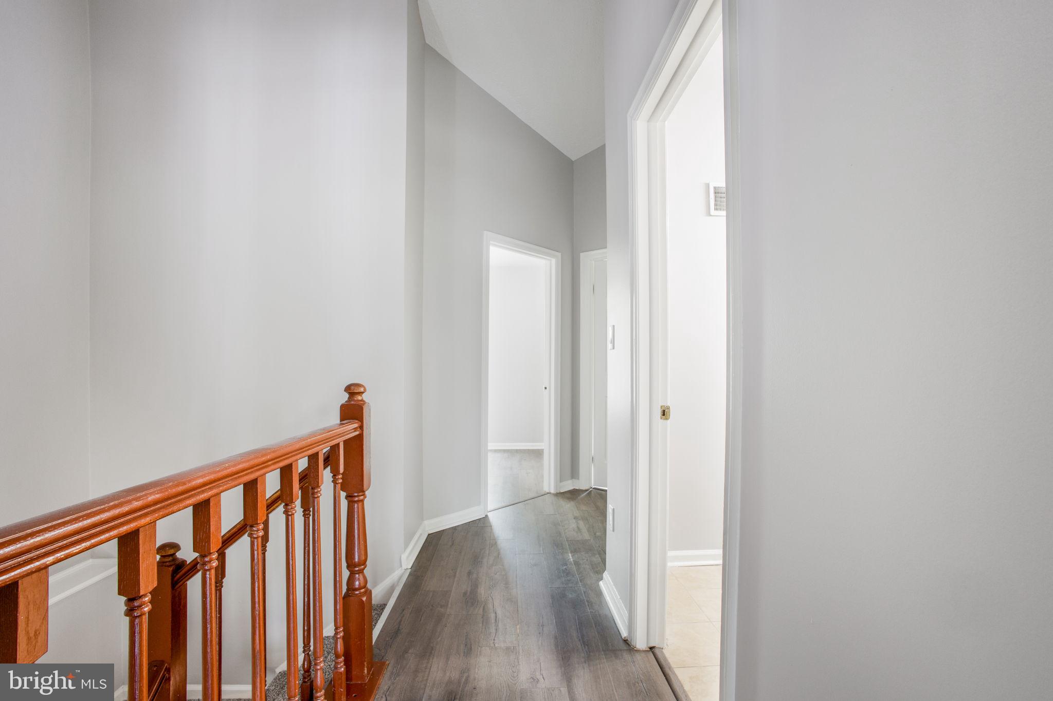 2102 Commissary Circle Odenton, MD 21113 - Photo 23 of 54 a view of a hallway with wooden floor and entryway