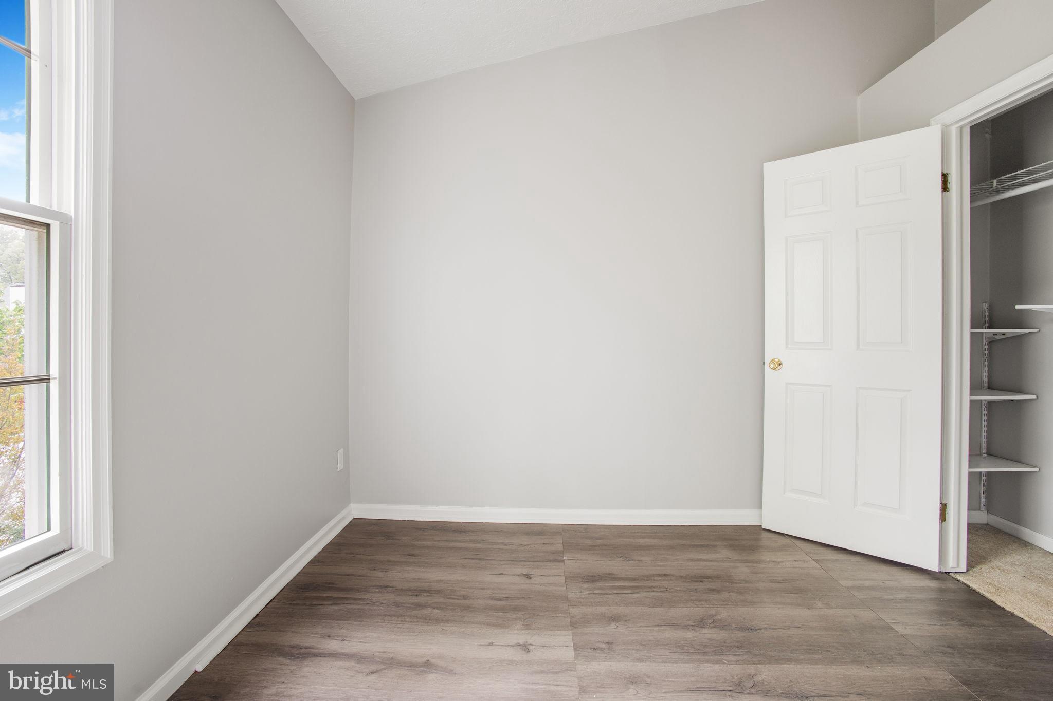 2102 Commissary Circle Odenton, MD 21113 - Photo 25 of 54 a view of an empty room with wooden floor and a window