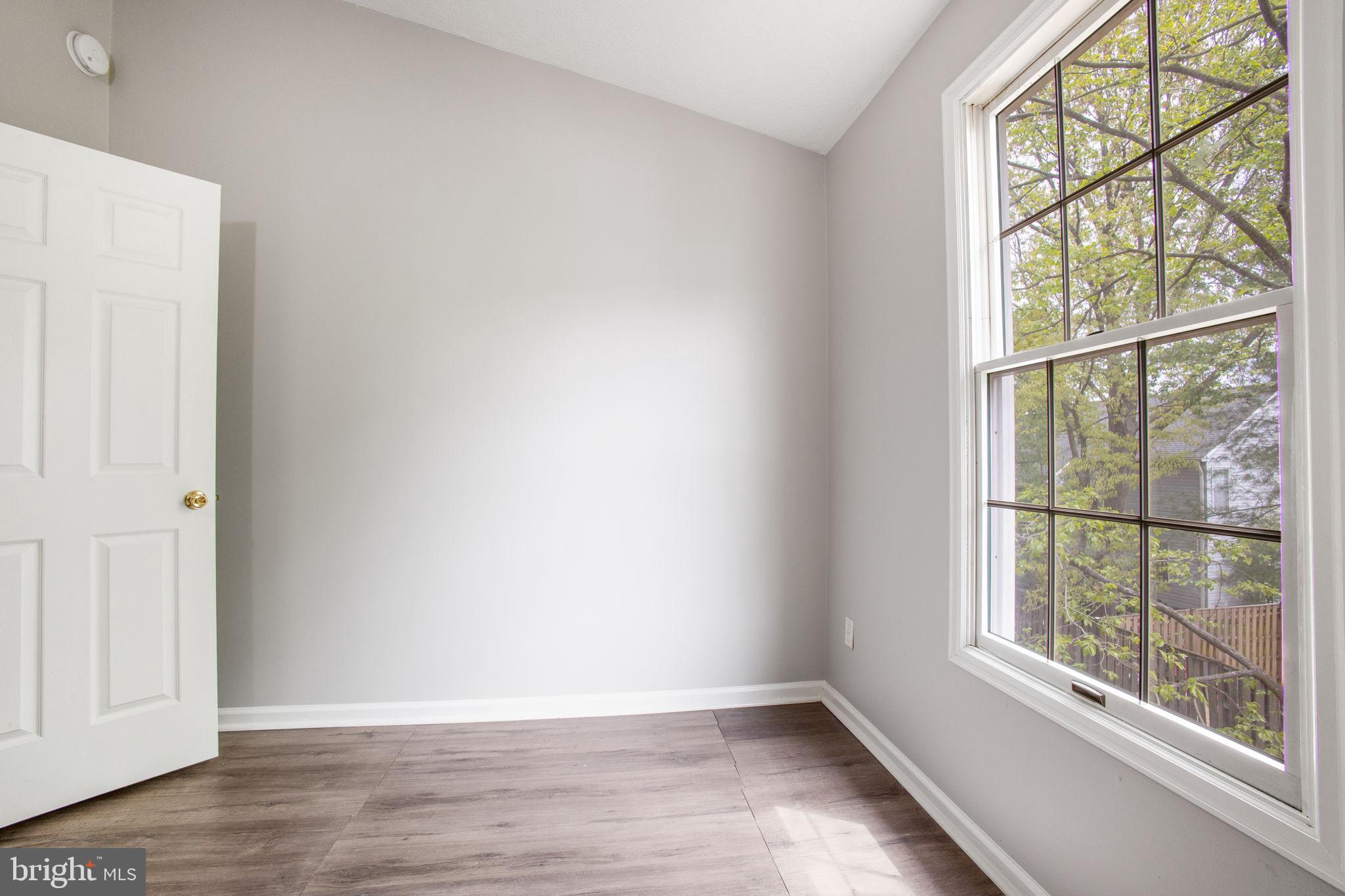 2102 Commissary Circle Odenton, MD 21113 - Photo 27 of 54 an empty room with wooden floor and windows