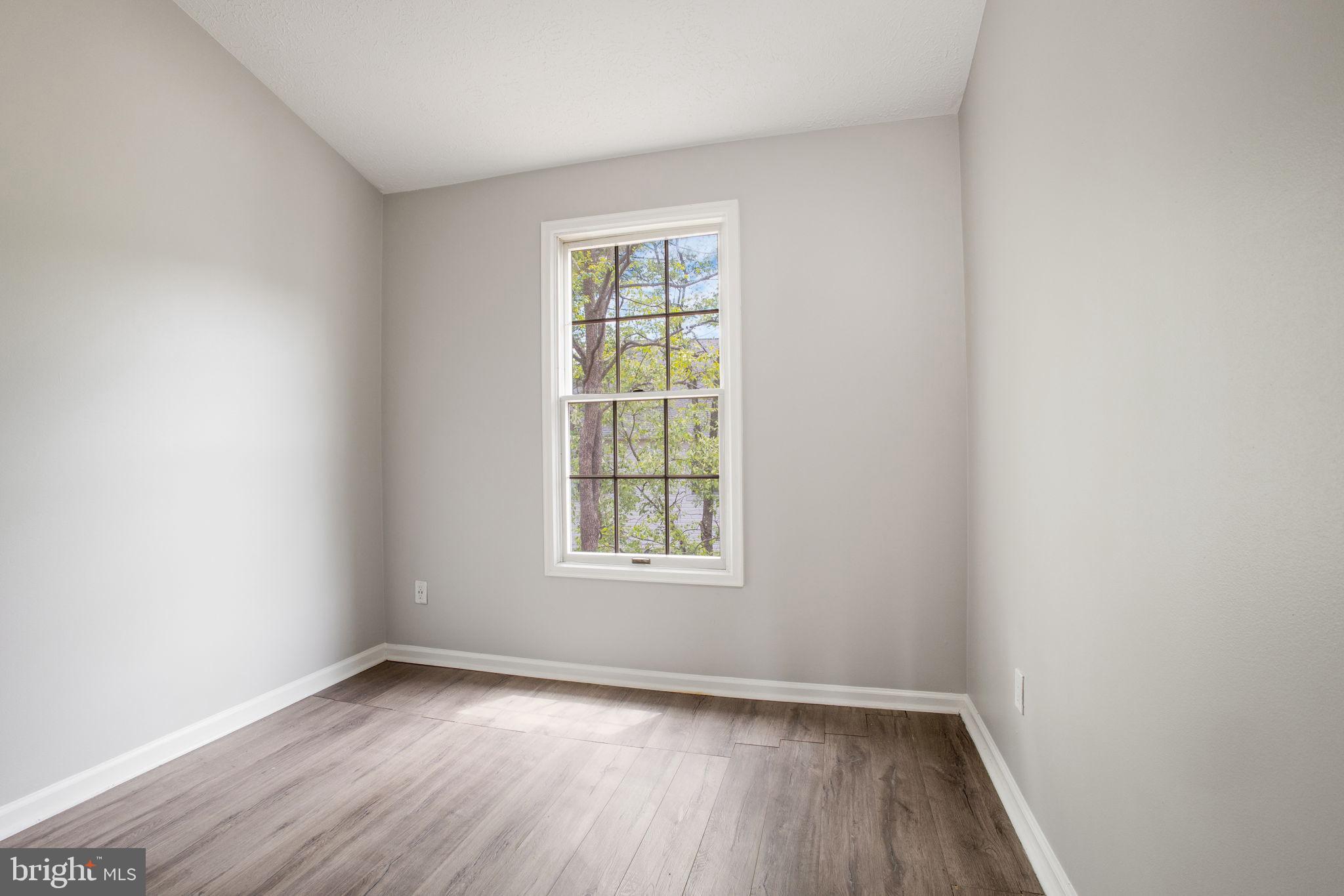 2102 Commissary Circle Odenton, MD 21113 - Photo 29 of 54 an empty room with wooden floor and windows