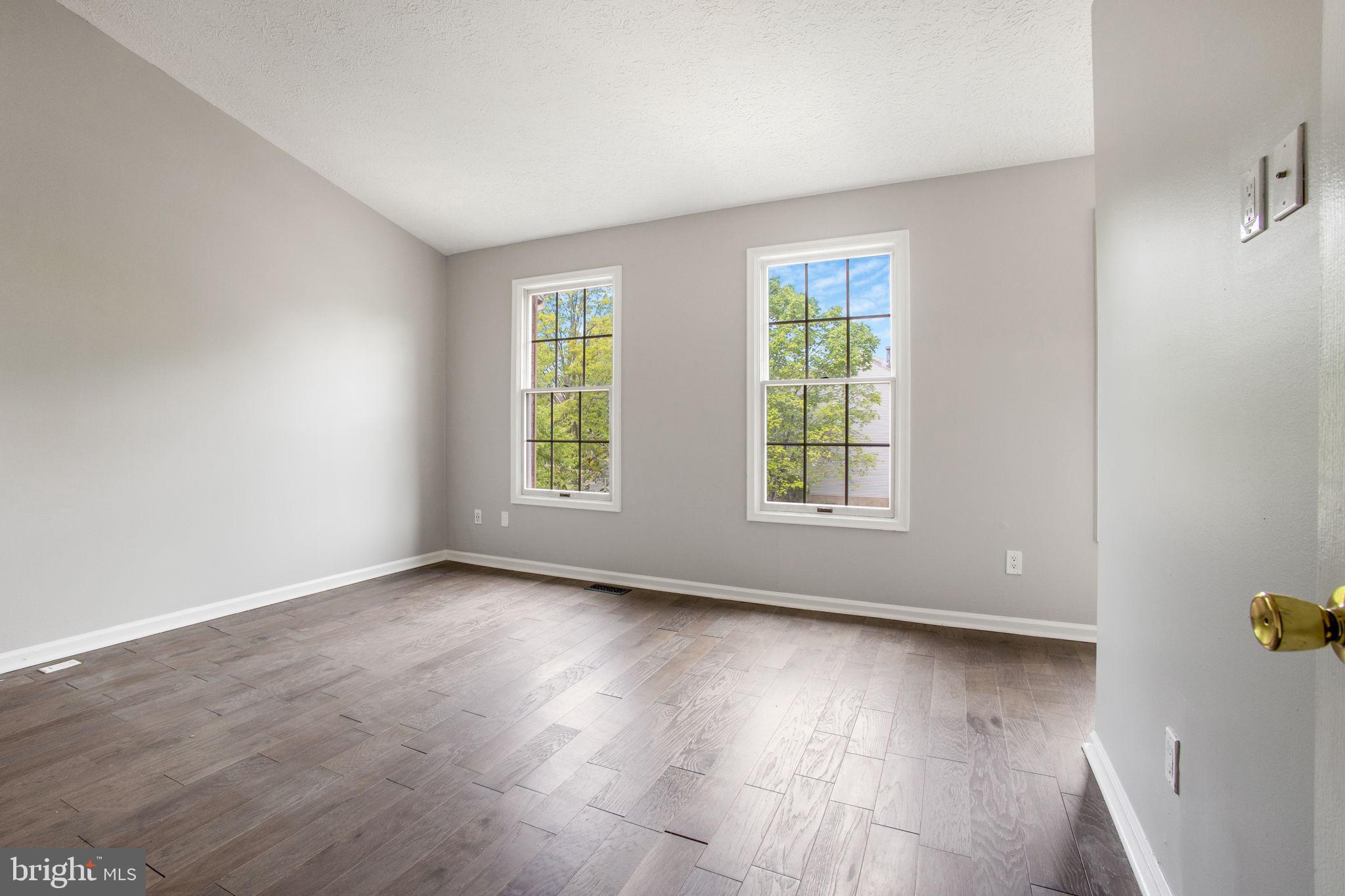 2102 Commissary Circle Odenton, MD 21113 - Photo 32 of 54 an empty room with wooden floor and windows