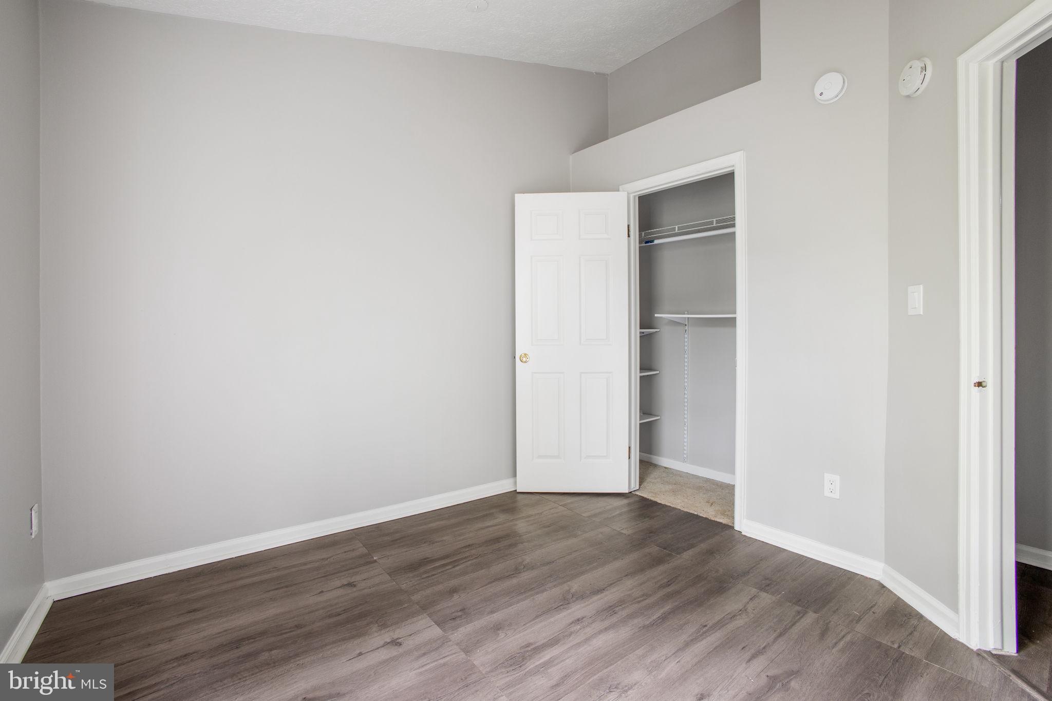 2102 Commissary Circle Odenton, MD 21113 - Photo 35 of 54 a view of an empty room with wooden floor and closet