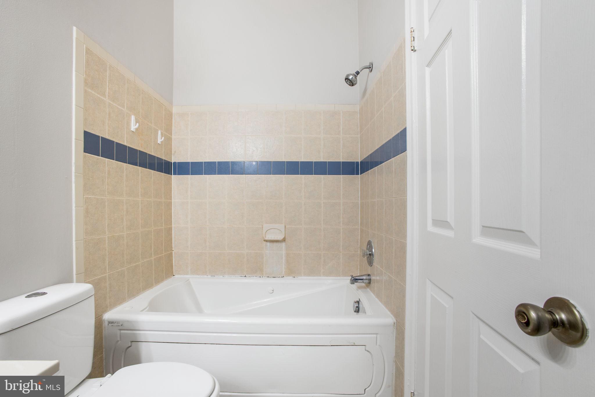 2102 Commissary Circle Odenton, MD 21113 - Photo 37 of 54 a bathroom with a toilet and a bathtub