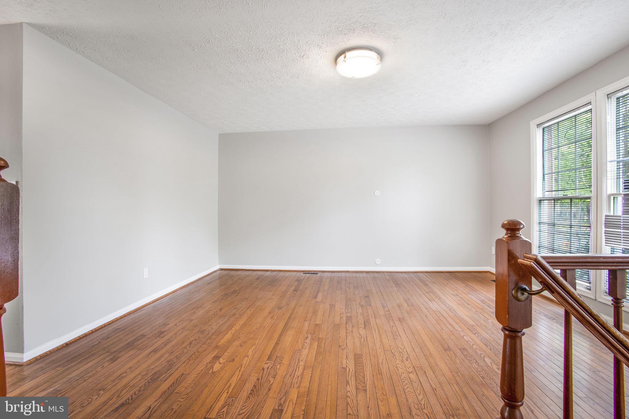 2102 Commissary Circle Odenton, MD 21113 - Photo 5 of 54 a view of a room with wooden floor and stairs