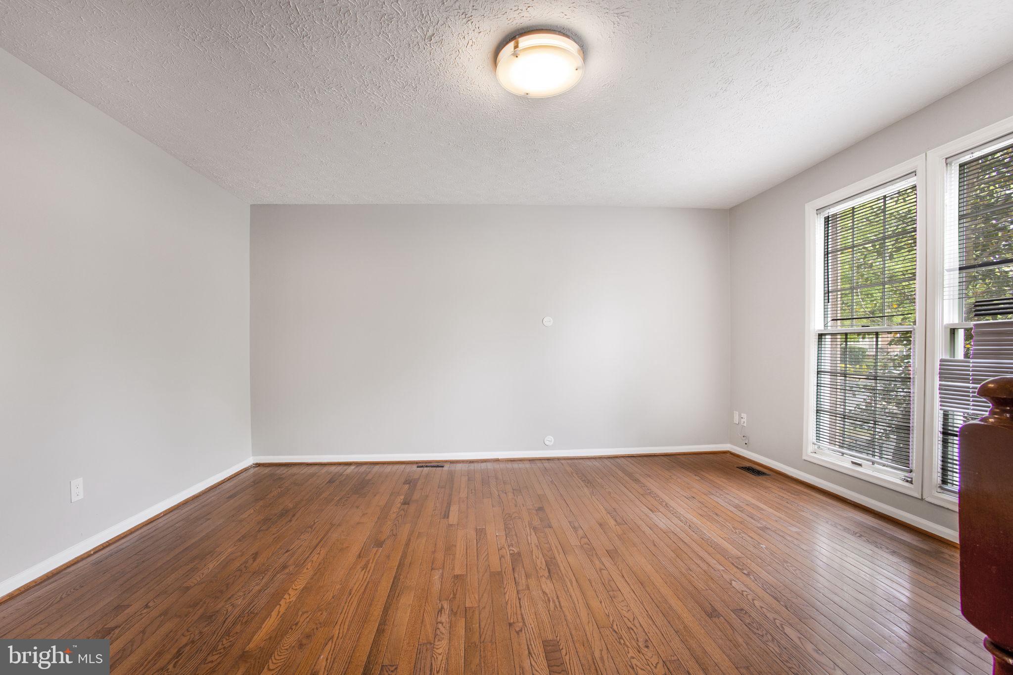 2102 Commissary Circle Odenton, MD 21113 - Photo 10 of 54 an empty room with wooden floor and windows