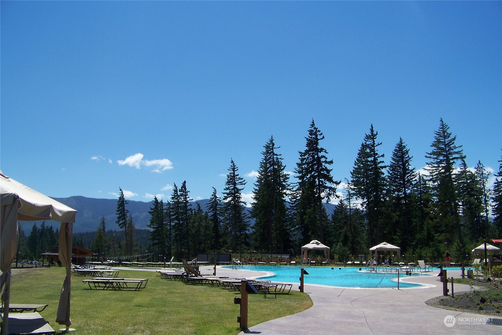961 Larkspur Loop Cle Elum, WA 98922 - Photo 14 of 17 a view of swimming pool with lawn chairs and a fire pit