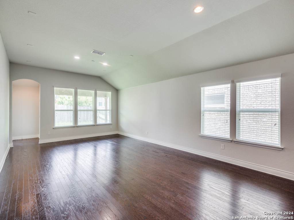 129 Aberdeen Boerne, TX 78015 - Photo 4 of 12 a view of an empty room with wooden floor and a window