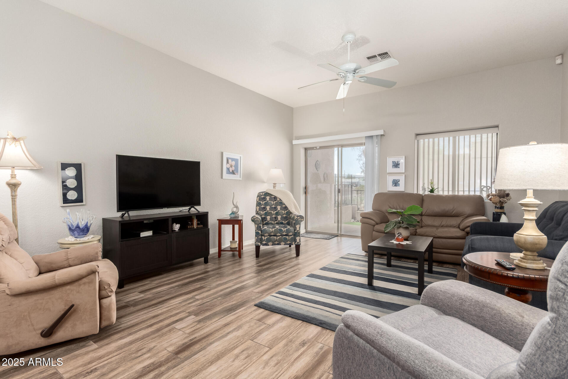2368 West 10th Avenue Apache Junction, AZ 85120 - Photo 1 of 30 a living room with furniture a ceiling fan and a flat screen tv