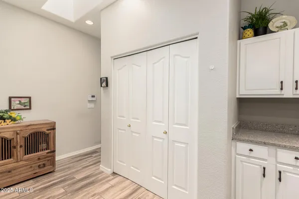 a kitchen with white cabinets and white appliances