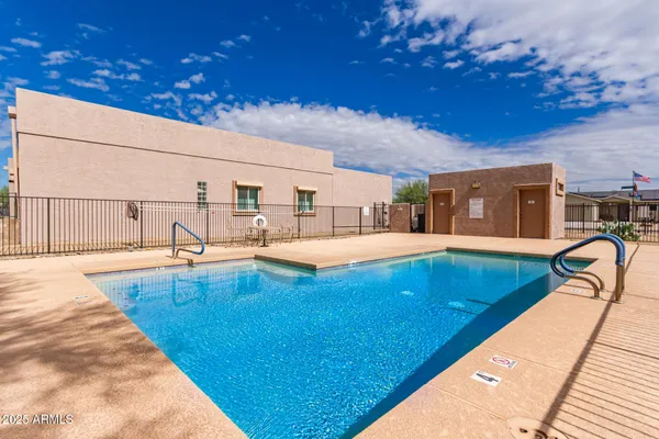 a swimming pool with outdoor seating and yard