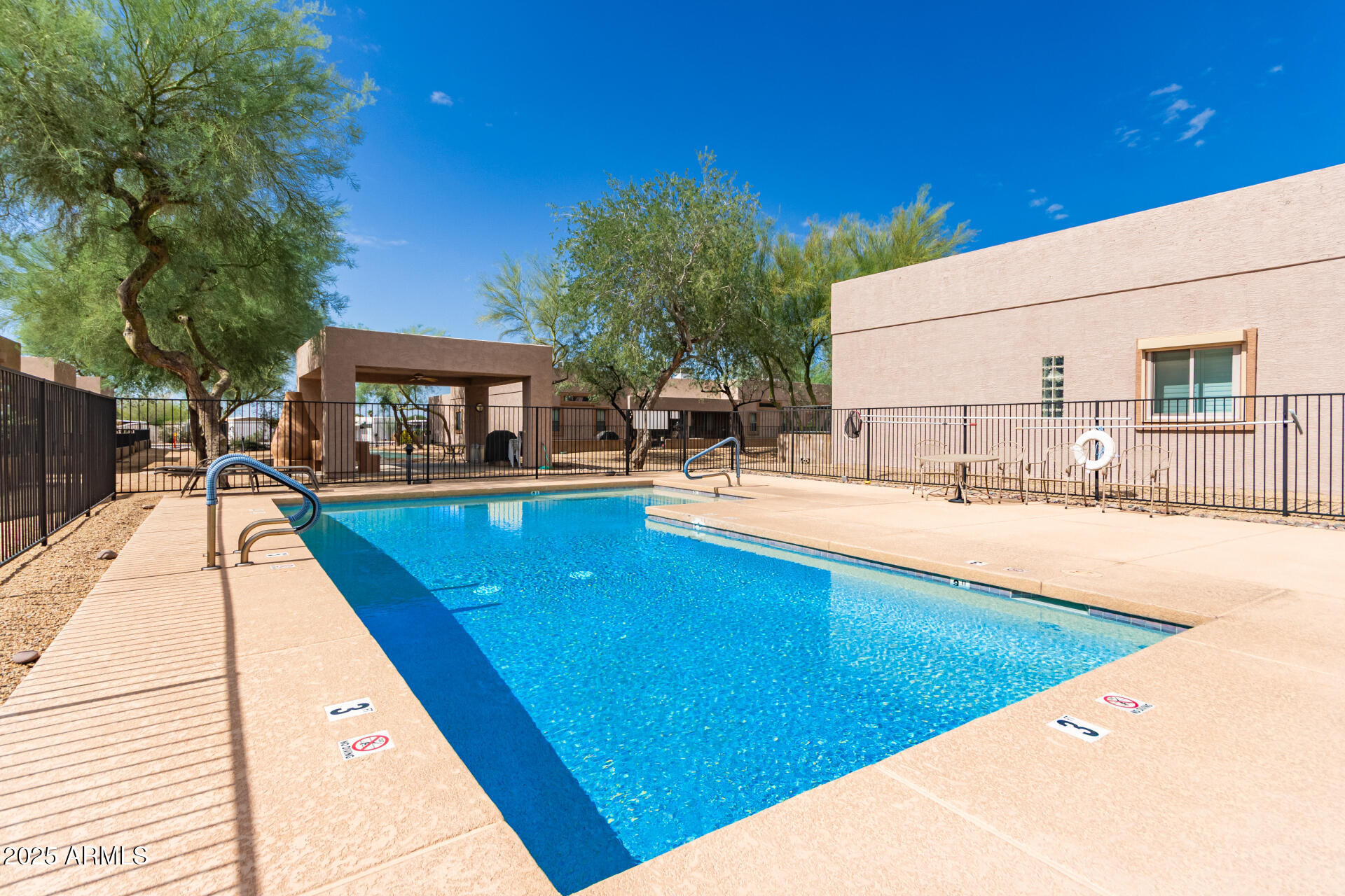 2368 West 10th Avenue Apache Junction, AZ 85120 - Photo 28 of 30 a swimming pool with outdoor seating and yard