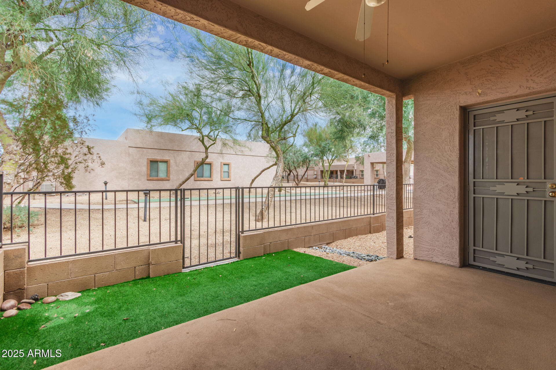 2368 West 10th Avenue Apache Junction, AZ 85120 - Photo 3 of 30 a view of a house with a small yard and wooden fence