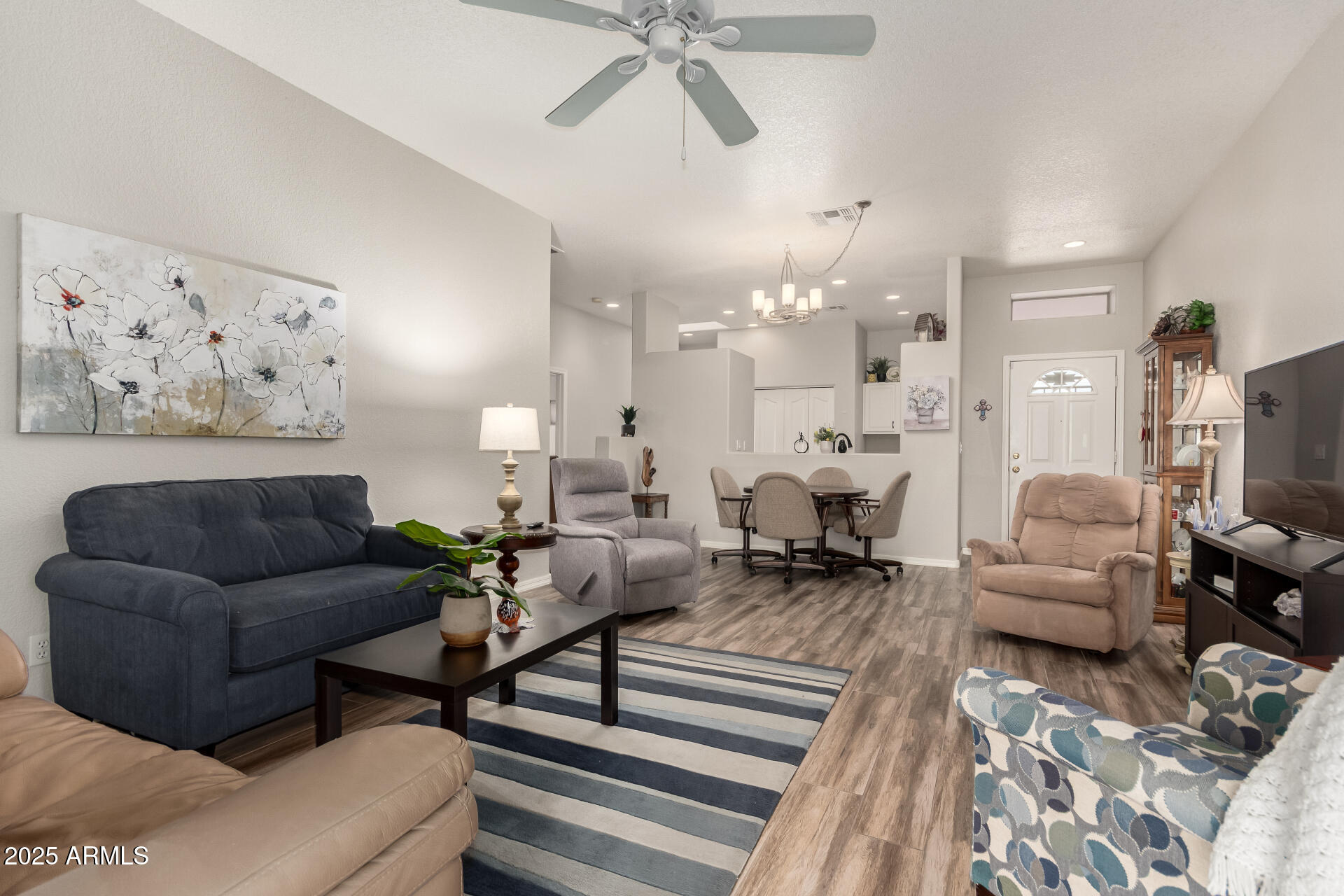 2368 West 10th Avenue Apache Junction, AZ 85120 - Photo 7 of 30 a living room with furniture and a chandelier