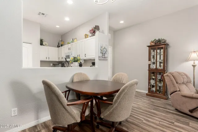 a dining room with furniture and wooden floor