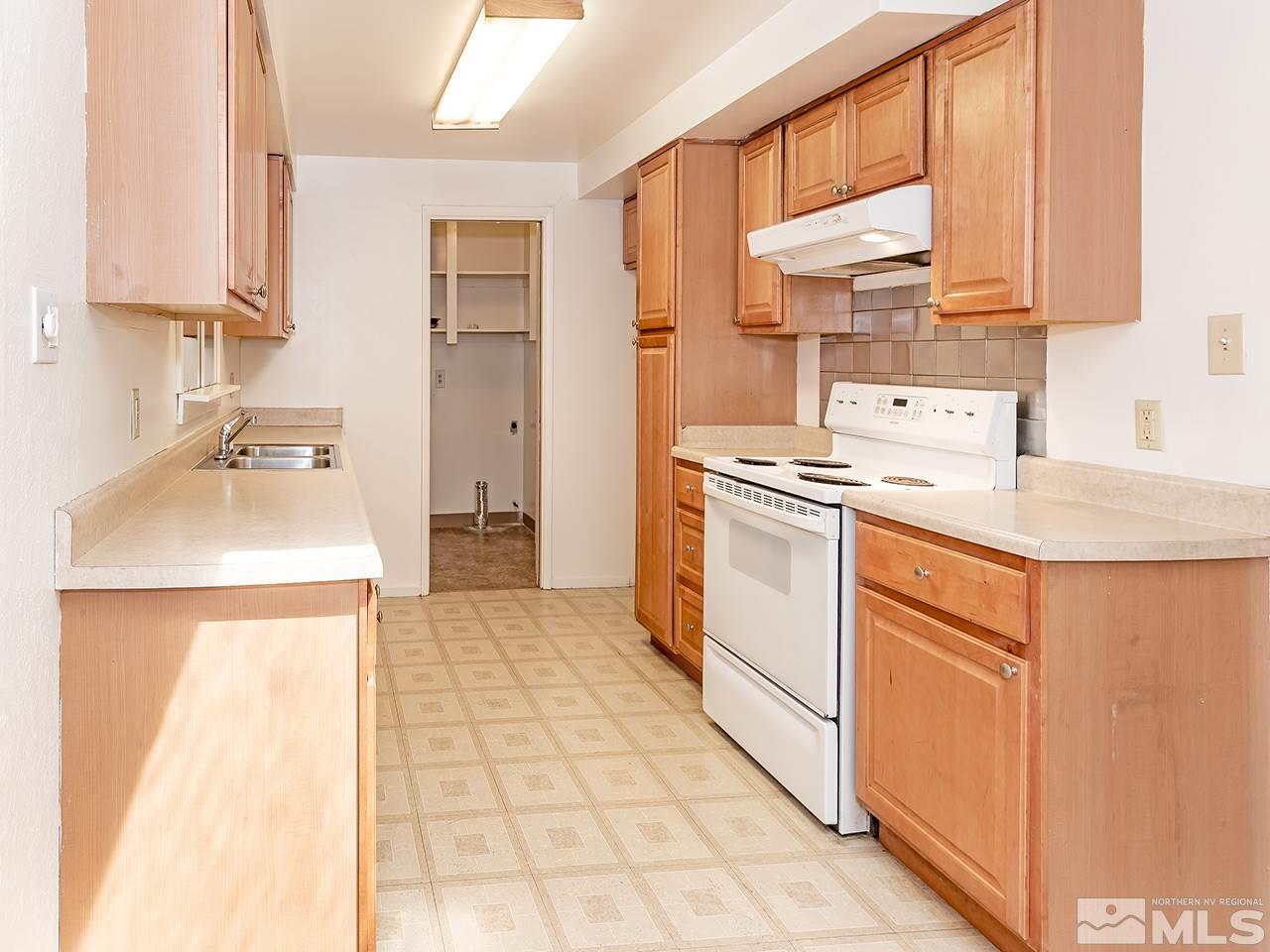 1775 West 6th Street Reno, NV 89503 - Photo 5 of 15 a kitchen with a stove a sink and a refrigerator